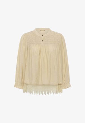 Cremefarbene Langarmbluse mit geraffter Brustpartie, rundem Ausschnitt, Knopfleiste, weitem Schnitt und Spitzenbesatz am Saum.