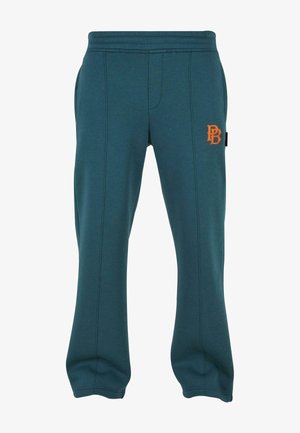Teal svedpants med orange logo, lavet af blødt stof. Har sidelommer, elastisk talje og teksturerede sømdetaljer.