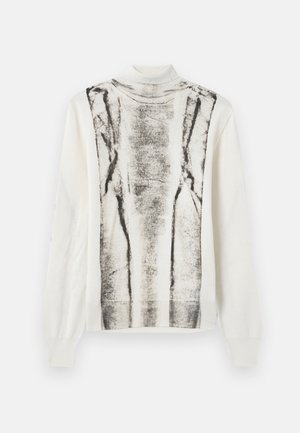 Pull léger en crème avec un col haut. Présente un motif abstrait noir et gris à l'avant. Manches longues avec des poignets côtelés.