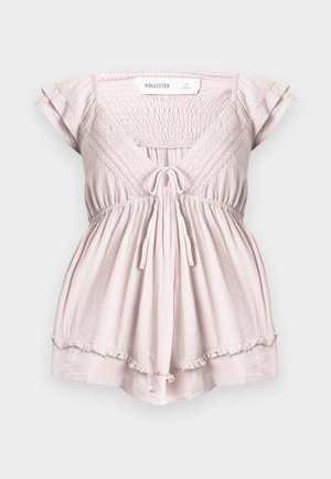 Ροζ ανοιχτό ροζ ολόσωμο σορτς με κοντά μανίκια, σούρα στο μπούστο, λεπτομέρειες από δαντέλα, δέσιμο μπροστά και βολάν στο τελείωμα από τη Hollister σε μέγεθος μικρό.