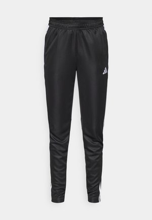 Zwarte sportbroek gemaakt van glad, lichtgewicht stof, met een elastische tailleband en witte zijkanten met een klein logo op de linkerdij.