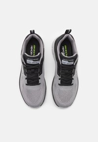 Gray mesh sneakers with a black accent, featuring black laces, a memory foam insole, and a lightweight sole. Branding on the tongue.