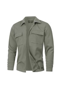 Olivegrünes Langarmhemd mit Reißverschluss vorne, zwei Brusttaschen und klassischem Kragen. Weicher Stoff mit strukturiertem Oberflächendesign.
