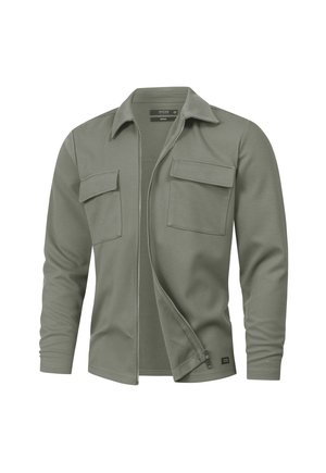 Olivegrünes Langarmhemd mit Reißverschluss vorne, zwei Brusttaschen und klassischem Kragen. Weicher Stoff mit strukturiertem Oberflächendesign.