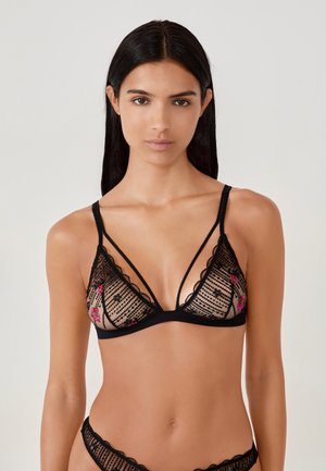 Black lace bralette featuring floral embroidery, sheer panels, scalloped edges, and adjustable straps for a delicate, intricate design.