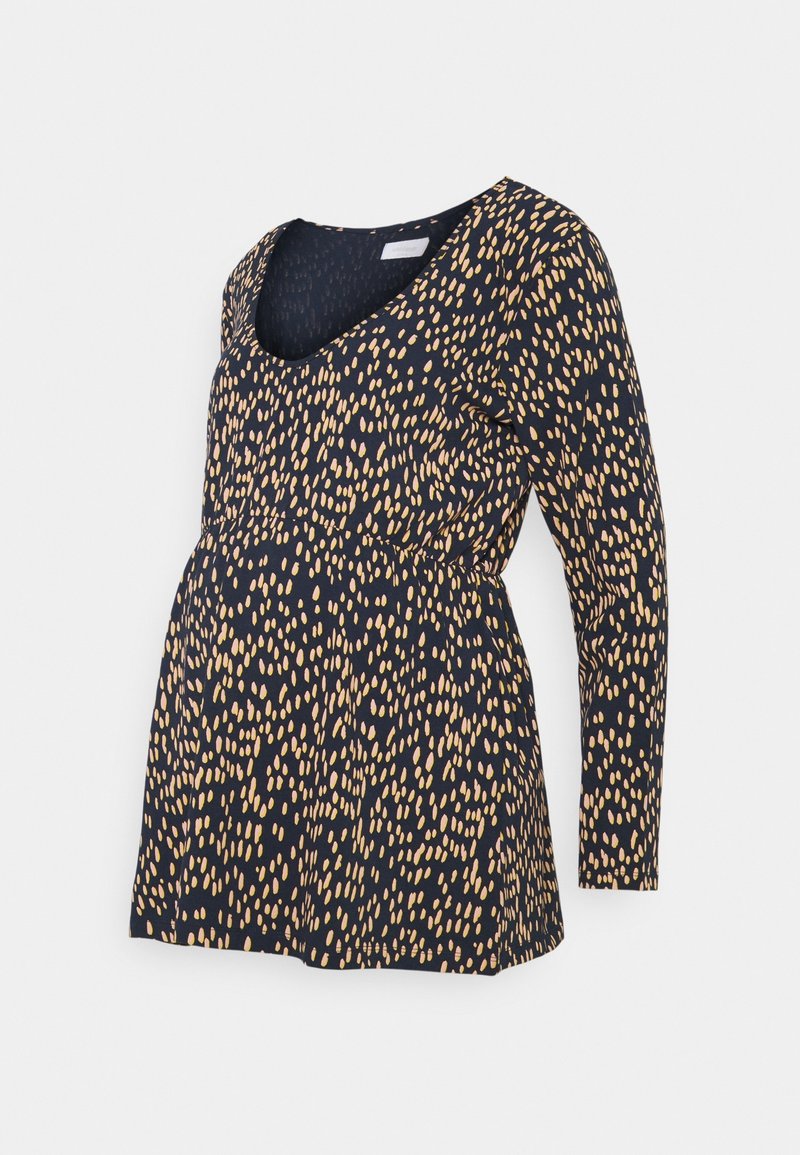 Gravidtröja med långa ärmar, marinblå bas och spridd beige oval mönster, med en rundad halsringning och samlad midjedetalj.