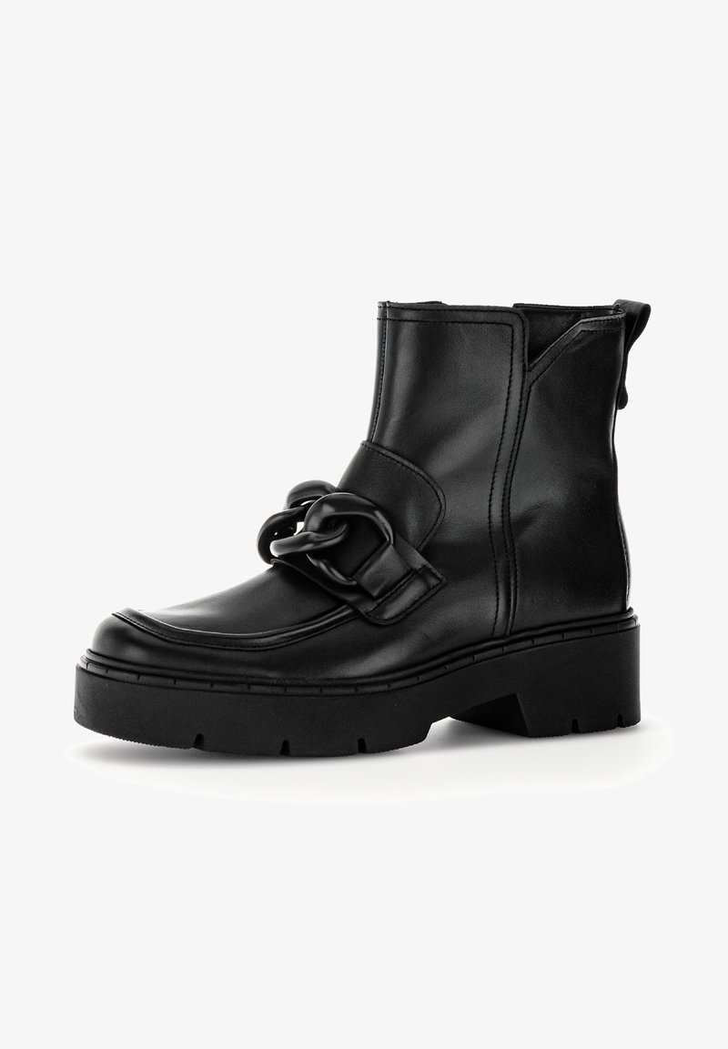 Bottine en cuir noir à la semelle épaisse, ornée d'une grande boucle décorative. Dotée d'une texture lisse et d'une fermeture éclair latérale pour un enfilage facile.