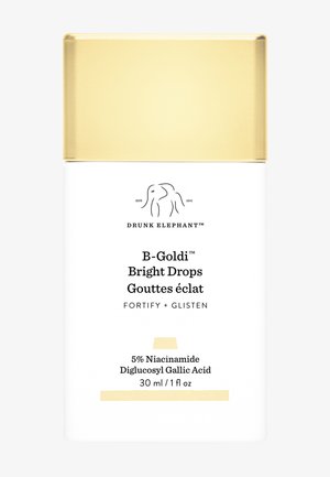 Drunk Elephant B-Goldi Bright Drops in a white bottle with a gold cap. Features brand logo, product name, and ingredient details on the label.