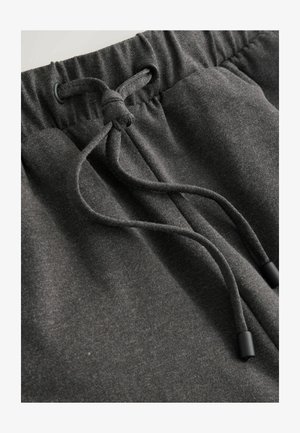 Anthrazitgraue Jogginghose mit Kordelzugbund und schwarzen Kunststoffenden, weichem Stoff und lockerem Schnitt.