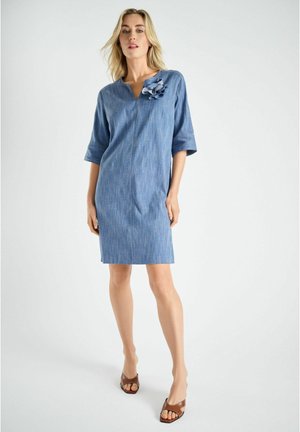 Blauwe denimjurk met een V-hals, korte mouwen en een bloemaccent op de borst. Glad oppervlak met een rechte silhouet.