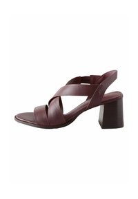 Burgundy leather heeled sandal with crisscross strap design, open toe, and block heel. Smooth texture and adjustable ankle strap.