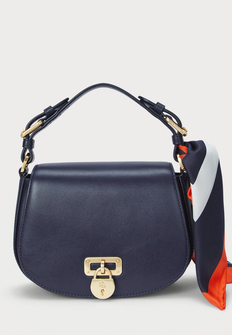 Navy leather handbag with a gold clasp, rounded shape, structured design, and a decorative scarf in orange, white, and navy colors.