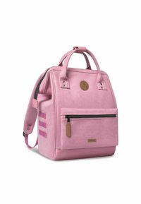 Pink backpack with synthetic material, dual top handles, adjustable shoulder strap, front zip pocket, and a circular logo on the front.