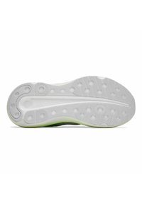 Sole of a shoe in white rubber with textured detailing, featuring circular grips and a green accent on the edge, designed for traction.