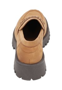 Tan suede shoe with a rounded toe, brown sole, and metal accents on the vamp. Features a textured surface and visible stitching detail.