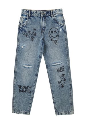Jean en denim bleu clair délavé avec des imprimés graphiques noirs, comprenant un sourire, des éclaboussures, et le texte « NE PANIQUEZ PAS. »
