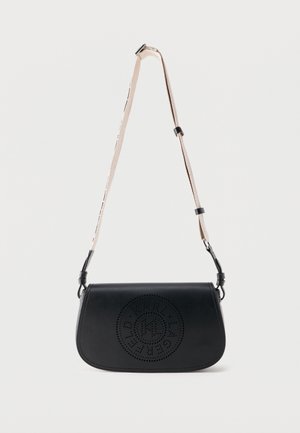 Mustast nahast õlakott reguleeritava beeži rihmaga ja esiklapil ümmarguse perforatsiooniga logodisain.