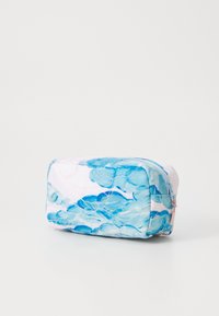 Quilted fabric cosmetic bag in white and blue hues, featuring a floral pattern and a zip closure. Compact rectangular shape with soft texture.
