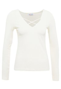 Vaaleansävyinen pitkähihaine paita, jossa on V-kaula-aukko ristiin menevällä muotoilulla. Pehmeä, sileä kangas, joka on muotoiltu tiukasti ja jossa on minimoitu saumat.