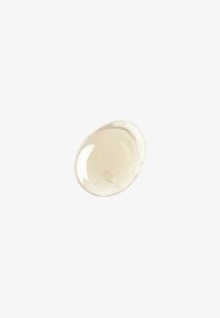 Genomskinlig geléliknande substans, ljusbeige i färgen, med bubblor och en slät glans, som liknar en droppe eller klump.