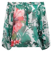Blouse transparente à épaules dégagées avec imprimé de feuilles tropicales vertes et grandes fleurs roses, encolure élastique et cordon de serrage avec pompons verts.
