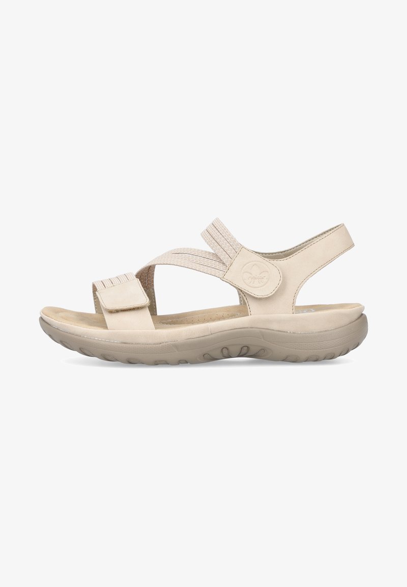 Sandalias beige con correas texturizadas, cierre ajustable de gancho y bucle, plantilla acolchada y suela de goma flexible para mayor comodidad.