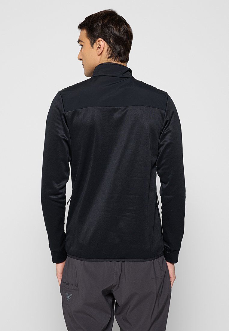 Czarny długi rękaw pulower z wysokim kołnierzem, wykonany z gładkiej tkaniny. Posiada kontrastowy górny panel oraz boczną kieszeń zapinaną na zamek.