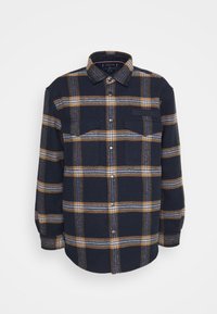 Camicia in flanella a quadri blu navy con strisce gialle e bianche, due tasche frontali, design con bottoni e patch con logo sul petto, tessuto testurizzato.