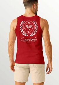 Rotes Tanktop mit einem gedruckten Design von gekreuzten Tennisrackets in einem kreisförmigen Emblem, umgeben von Lorbeerblättern und Text.