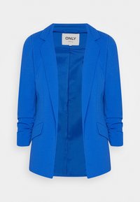 Ljusblå kvinnors kavaj med rynkade ärmar, framtill fickor med klaff och en öppen skräddarsydd design.