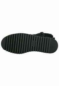 Suela de zapato de goma negra con ranuras horizontales, que presenta un pequeño logotipo grabado en el centro y una superficie texturizada para mayor agarre.