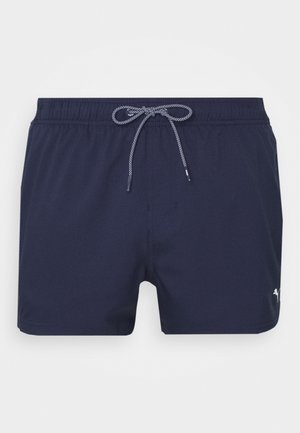 Dunkelblaue Badeshorts aus leichtem Material, mit einem elastischen Bund und Kordelzug sowie einem kleinen Logo an der Seite.