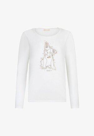 Dolga bela majica z dolgimi rokavi, izdelana iz bombaža, s potiskom psa, okrašenim z zlatimi bleščicami. Okrogla izrezana ovratnika z gladko teksturo.