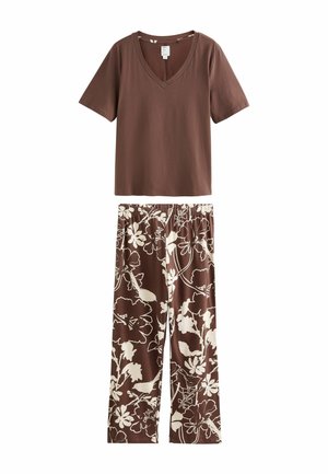 Brown short-sleeve V-neck top paired with brown loose pants featuring an off-white large floral pattern and elastic waistband.