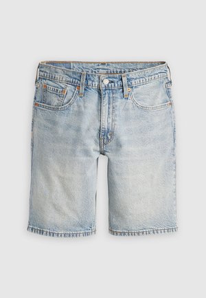 Light blue denim shorts feature a straight cut, five-pocket design, and frayed hem. Copper rivets accent the front and pockets.