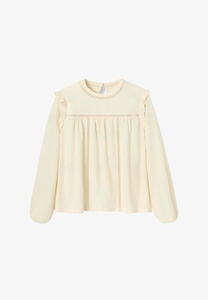 Haut crème à manches longues et col ras du cou avec accents à volants, devant plissé et détails de couture décoratifs. Texture douce, coupe décontractée.