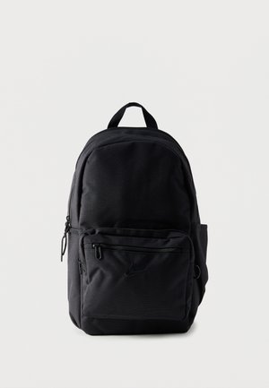 Musta kangasreppu, jossa useita vetoketjullisia lokeroita ja yläkahva, pystyssä yksinkertaisella vaalealla taustalla.