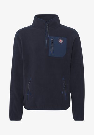 Tumesinine fliispullover kõrge kraega, pooltõmblukuga ees, rinna-tasku ja kahe küljetaskuga tõmblukuga. Omab siniseid aktsente ja logotähist.