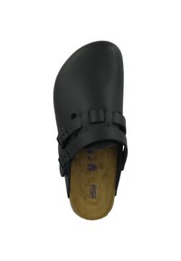 Black clogs made from smooth material, featuring dual buckle straps and a textured tan footbed. Shape is open-toe, with a rounded design.