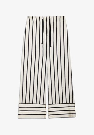 Pantalon blanc à jambes larges avec des rayures verticales noires et une taille à cordon noir, agrémenté de rayures horizontales aux poignets.