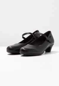 Zwarte leren Mary Jane-schoenen met een ronde neus, een band over de wreef en een lage hak. Glad oppervlak en minimalistisch ontwerp.