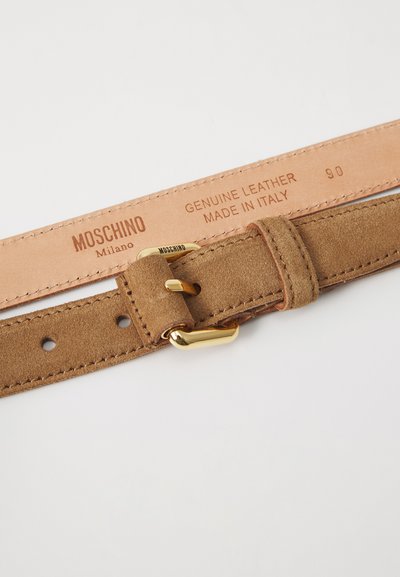 Pruun nubukist vöö kullast metallist pandlaga, millel on reguleerimiseks augud. Vahu pinnale on pressitud nahkmark, mis näitab "Genuine Leather, Made in Italy."