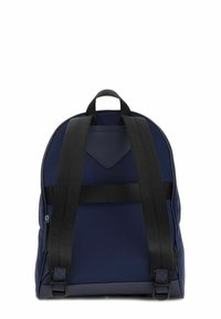 Sac à dos bleu marine avec des sangles noires, texture lisse, forme arrondie et un panneau d'accentuation à l'avant. Doté d'une poignée supérieure et d'une poche latérale zippée.