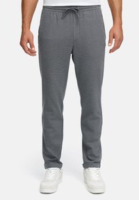 Graue Jogger-Hosen aus weichem Stoff, mit elastischem Bund und Kordelzug, schmal zulaufenden Beinen und minimalen Nähten.