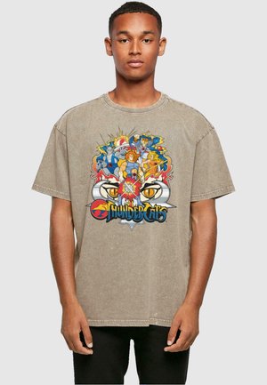 Beige oversize T-Shirt mit einem bunten "ThunderCats" Grafikdruck auf der Vorderseite, runder Ausschnitt und kurzen Ärmeln.