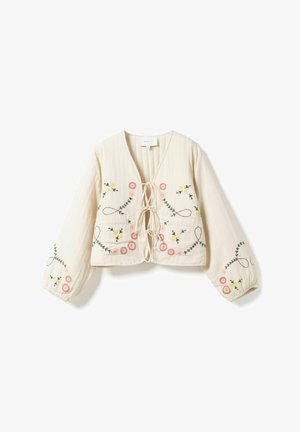 Krémová dlhá blúzka s krátkym strihom, predné šnurovanie a kvetinová výšivka v ružovej, žltej a zelenej farbe na hrudi a rukávoch.