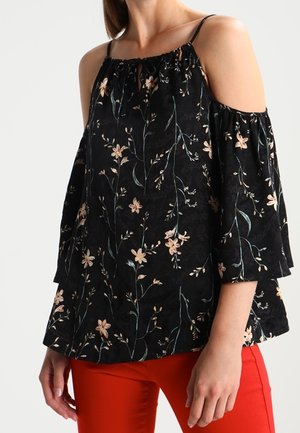 Haut noir décolleté avec imprime floral en rose et vert. Manches évasées et détails de col froncé, fabriqué en tissu doux.