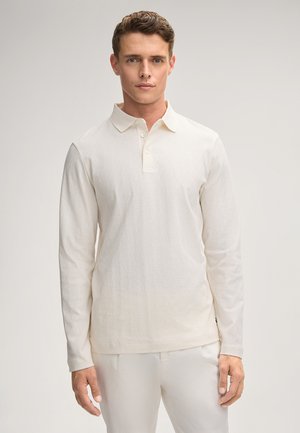 Long-sleeve polo shirt in cream, featuring a textured diamond pattern, three-button placket, and a classic collar design.