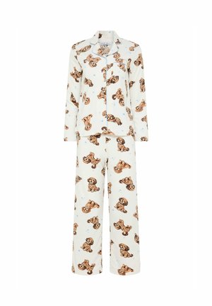 Ensemble de pyjama couleur crème avec haut boutonné et pantalon, présentant un motif répétitif de petits chiots marron et de cœurs bleu clair.