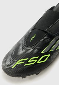 adidas Performance F50 CLUB UNISEX - Firm-ground football boots - core black/iron metal-coloured/lucid lemon